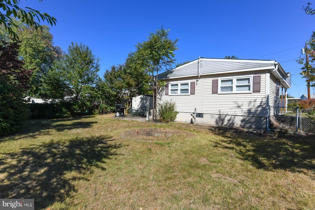 view of property exterior with a lawn