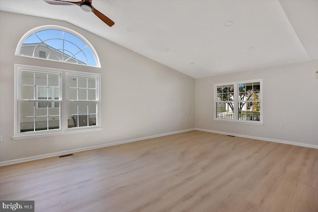 unfurnished room with light wood finished floors, visible vents, vaulted ceiling, and ceiling fan
