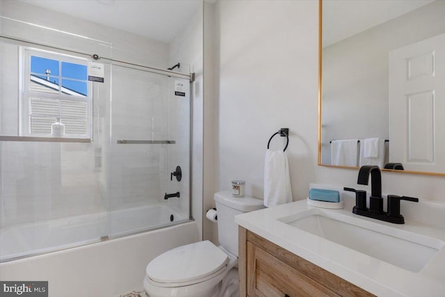 full bathroom featuring toilet, vanity, and combined bath / shower with glass door
