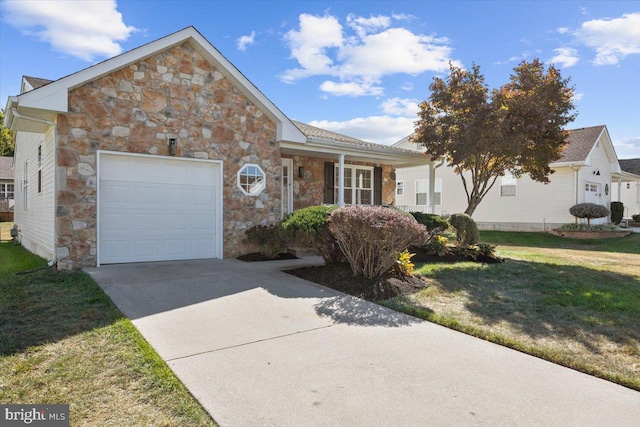 traditional home with concrete driveway, a front yard, stone siding, and an attached garage