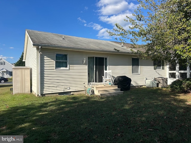 back of house with a lawn