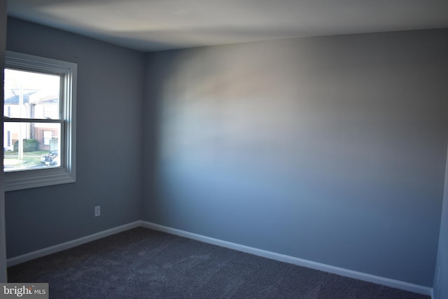 empty room featuring dark carpet