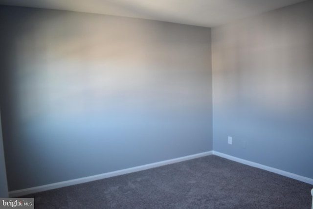 empty room with dark carpet