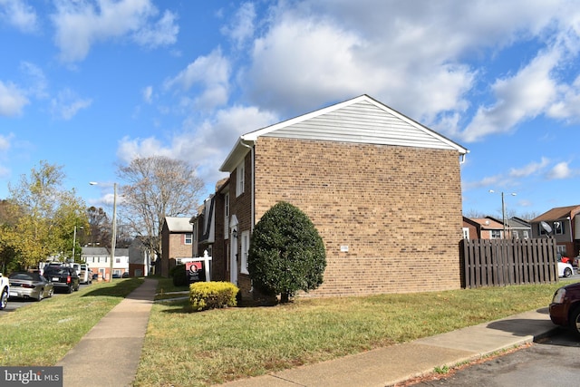 view of side of property with a lawn