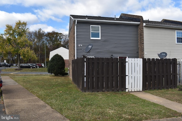 view of side of home with a yard