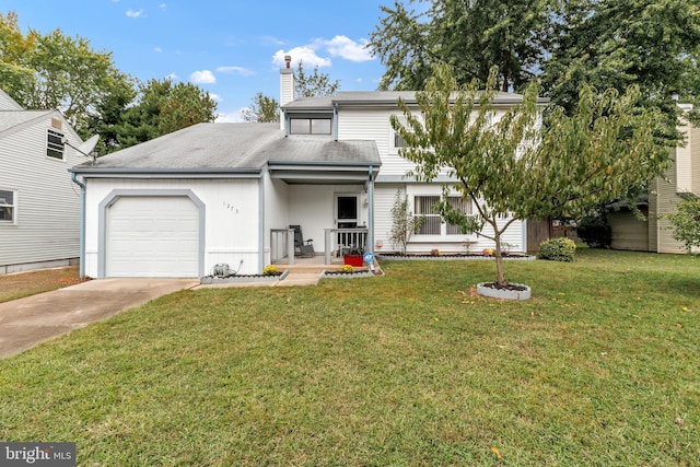 view of front facade with a front yard and a garage