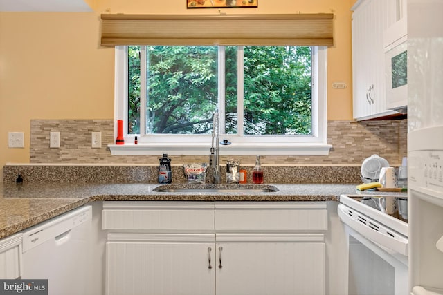 kitchen featuring white appliances, a wealth of natural light, and white cabinetry