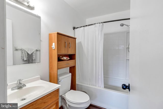 full bathroom with vanity, shower / bath combo with shower curtain, and toilet