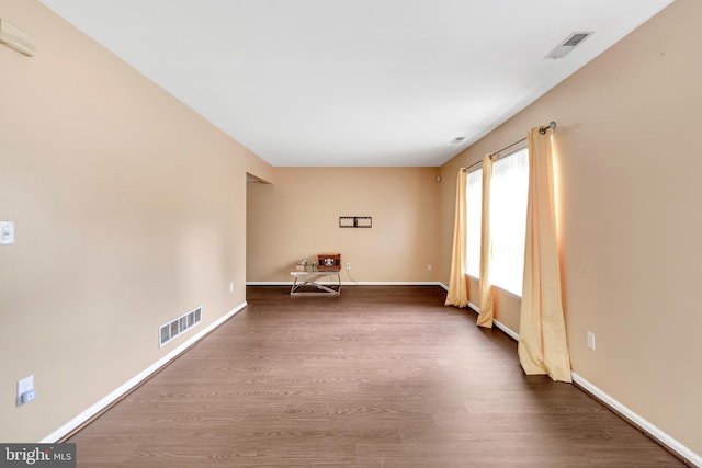 spare room featuring dark hardwood / wood-style flooring