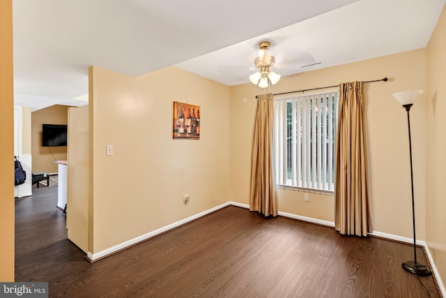 unfurnished room with dark hardwood / wood-style floors and ceiling fan