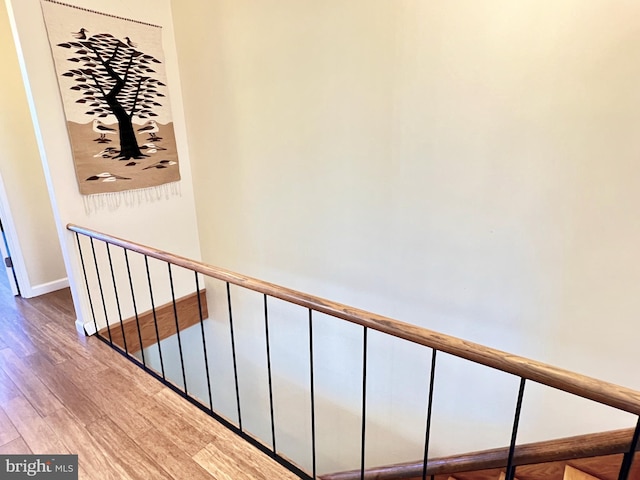 corridor with hardwood / wood-style flooring