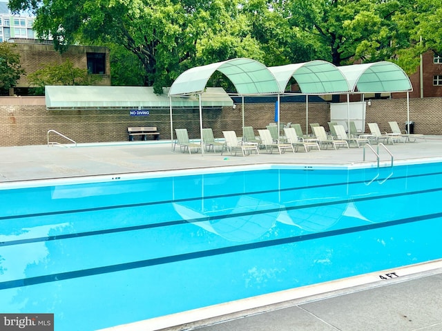 view of swimming pool featuring a patio