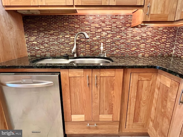 bar with dishwasher, sink, tasteful backsplash, and dark stone countertops