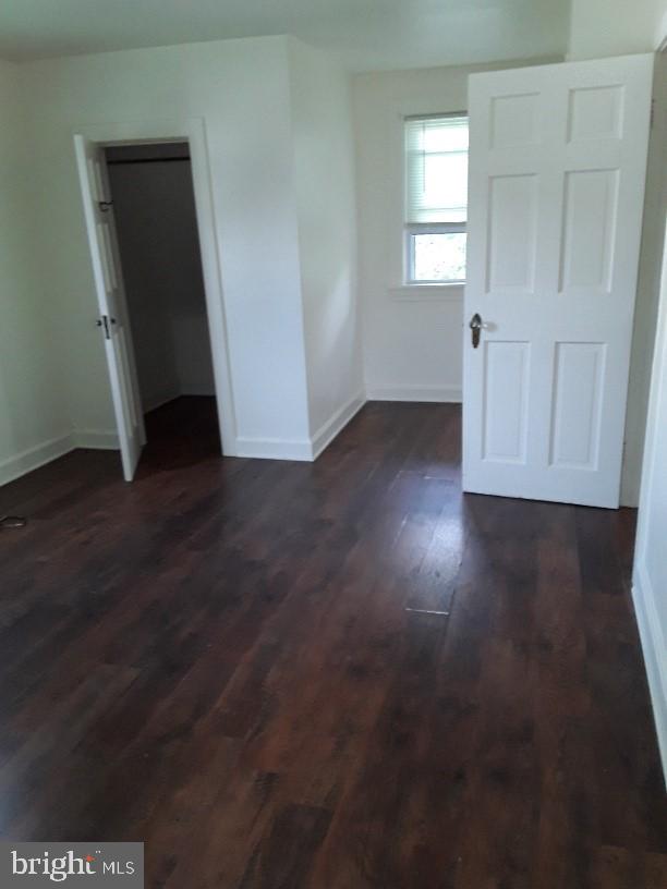 spare room featuring dark hardwood / wood-style floors