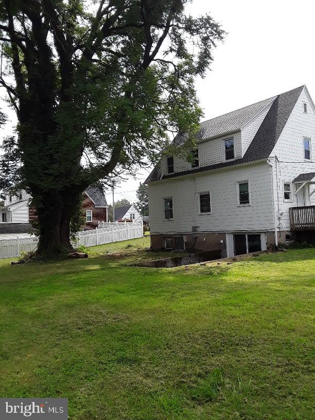 rear view of property with a yard