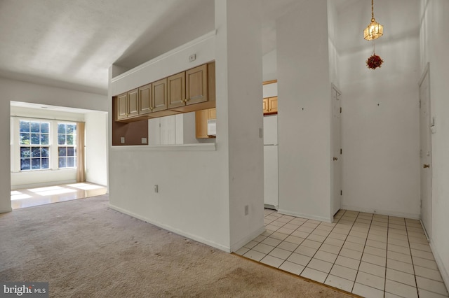 interior space featuring light carpet and vaulted ceiling