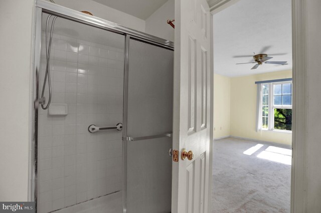 unfurnished room with light colored carpet and ceiling fan