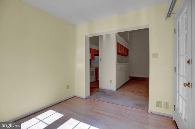 spare room with light hardwood / wood-style flooring