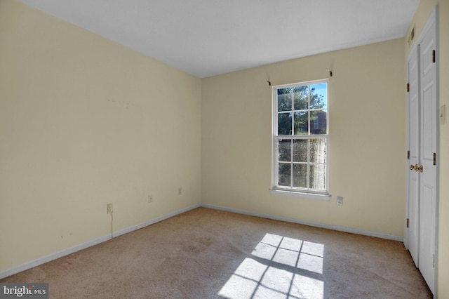 empty room featuring light carpet