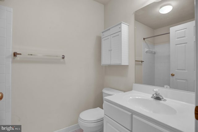 bathroom with walk in shower, vanity, and toilet