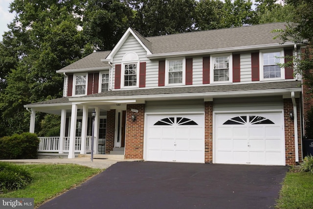 view of front of house with a garage and a porch