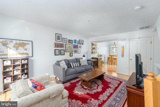 living room with hardwood / wood-style flooring and a textured ceiling