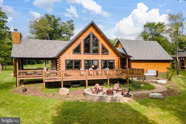 rear view of property featuring a wooden deck, cooling unit, a fire pit, a yard, and a patio