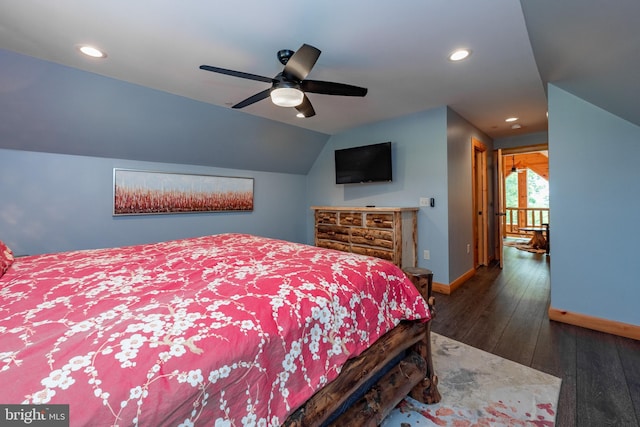 bedroom with ceiling fan, dark wood-type flooring, and vaulted ceiling