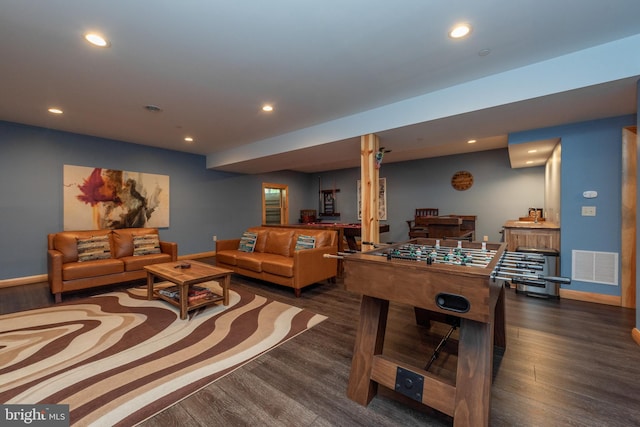 game room featuring dark wood-type flooring