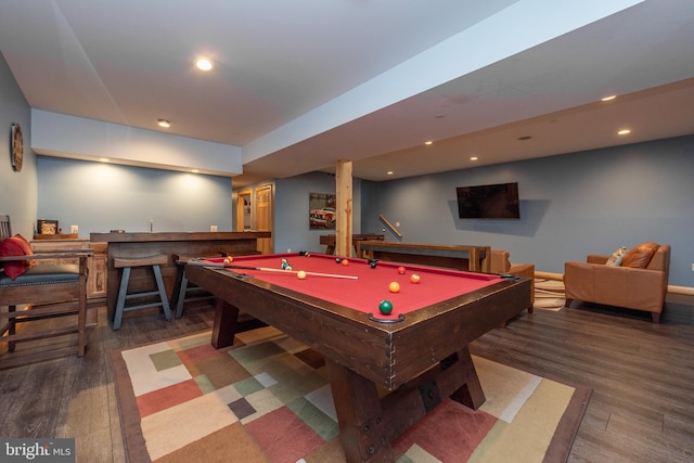 rec room with bar, dark wood-type flooring, and pool table