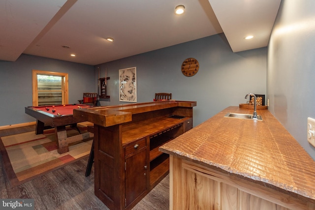 bar with dark hardwood / wood-style floors, sink, and pool table