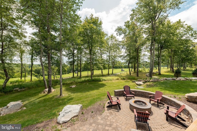 surrounding community with a yard, a patio, and an outdoor fire pit