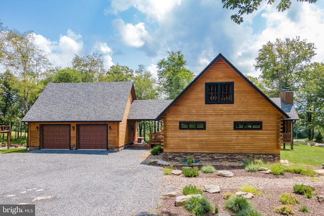 log-style house featuring a garage