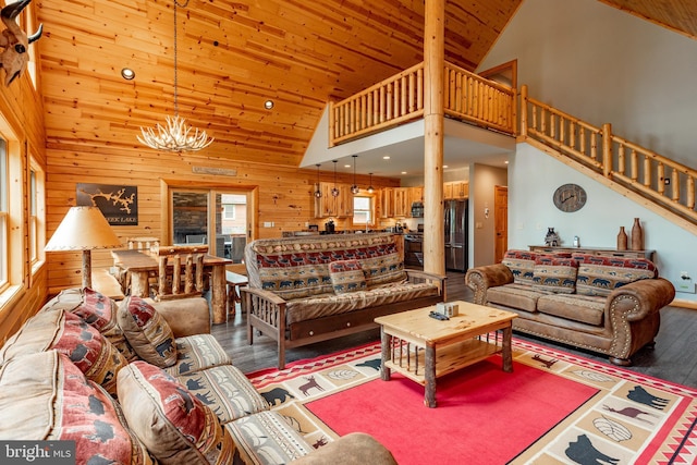 living room with hardwood / wood-style flooring, high vaulted ceiling, wooden ceiling, a notable chandelier, and wood walls