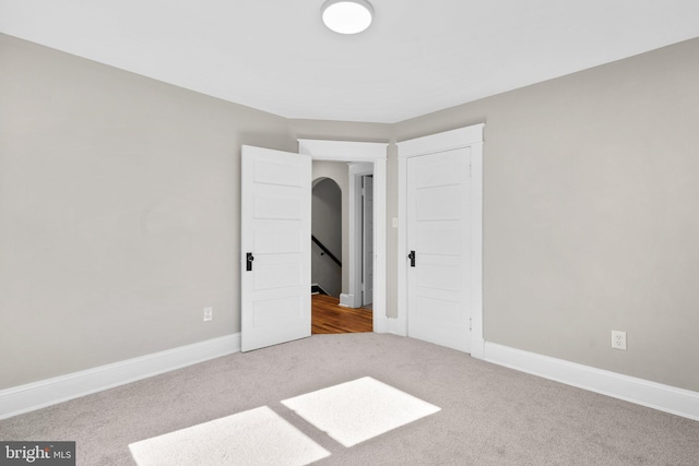 unfurnished bedroom featuring light colored carpet