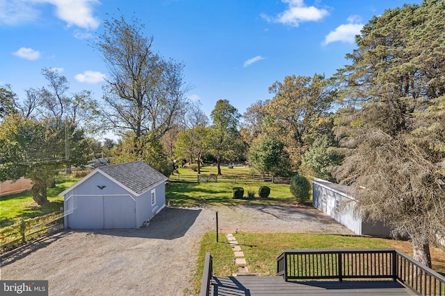 view of yard with a wooden deck and an outdoor structure