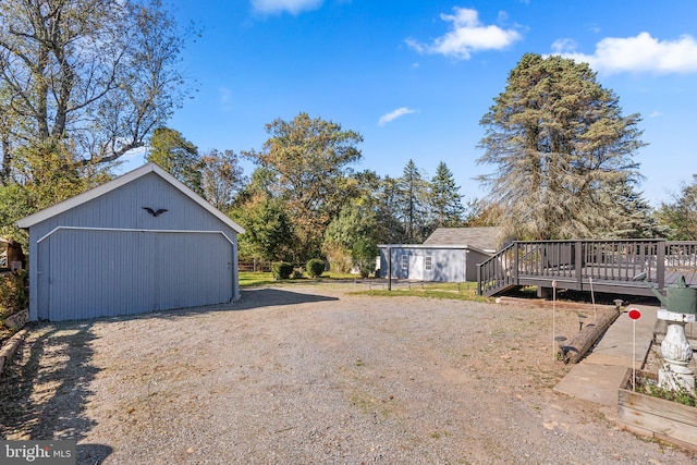 view of yard with a wooden deck and an outdoor structure