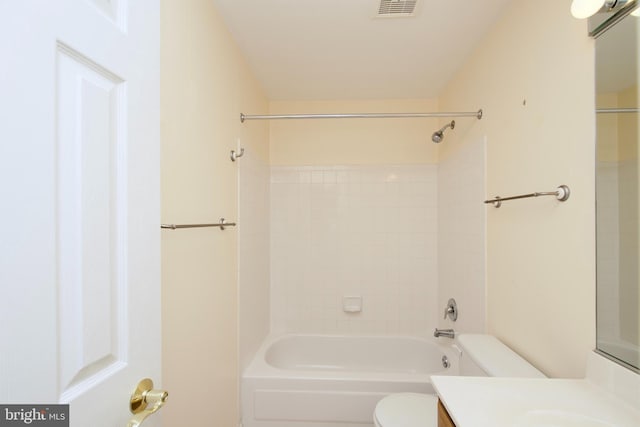 full bathroom featuring tiled shower / bath, vanity, and toilet