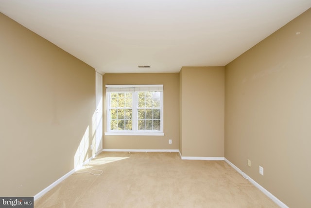 empty room featuring light colored carpet