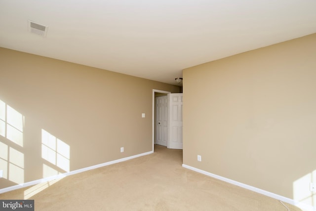 unfurnished room with light colored carpet