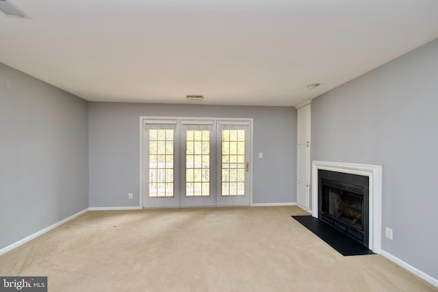 unfurnished living room featuring light colored carpet