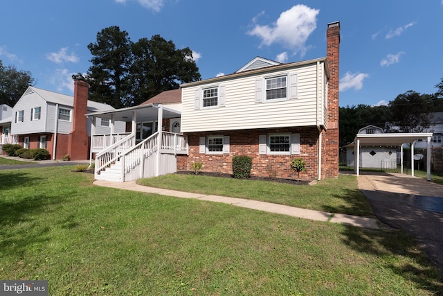 view of front of property with covered porch, a carport, and a front yard