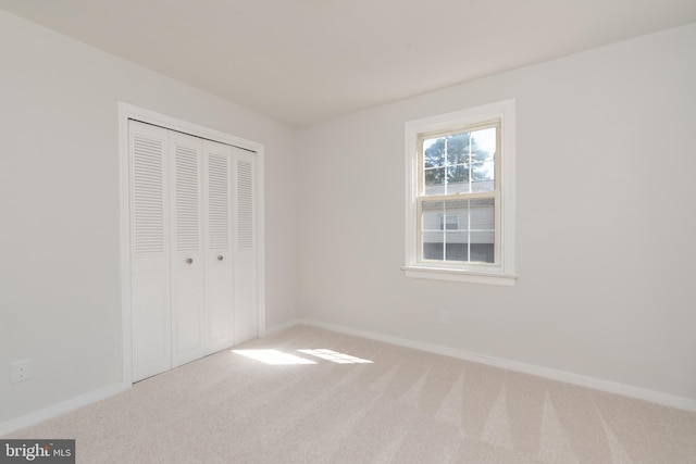 unfurnished bedroom featuring a closet and carpet flooring