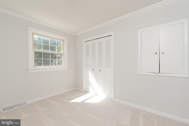 unfurnished bedroom with crown molding and light carpet