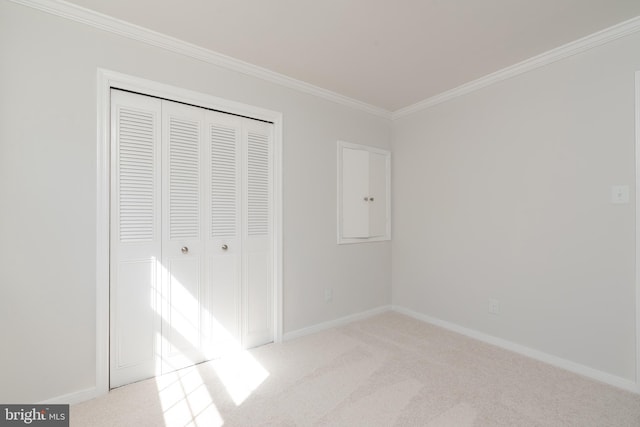 unfurnished bedroom featuring light carpet, a closet, and ornamental molding