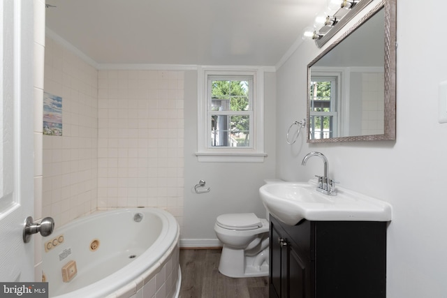 bathroom featuring vanity, toilet, a bathtub, hardwood / wood-style flooring, and ornamental molding