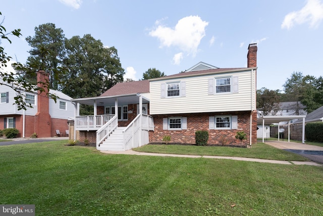 tri-level home featuring a carport and a front yard