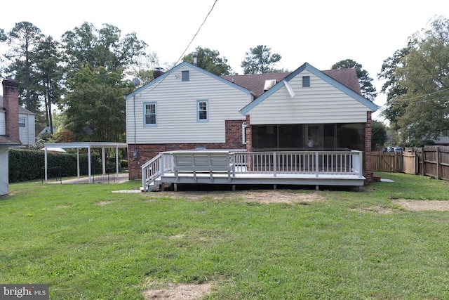 back of property featuring a wooden deck and a lawn