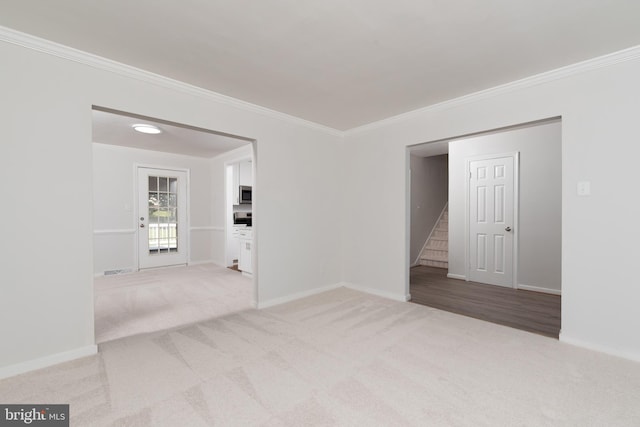 carpeted spare room with crown molding