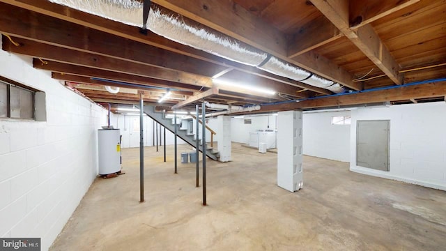 basement with gas water heater and washing machine and dryer